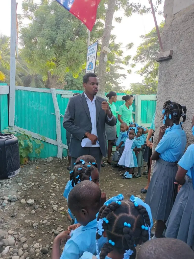 A man speaking to a group of students in uniform